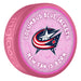 NHL Columbus Blue Jackets New Fan Is Born pink souvenir hockey puck with star and stripes cannon logo on baby-themed background
