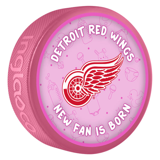 NHL Detroit Red Wings New Fan Is Born pink souvenir hockey puck with red winged wheel logo on baby-themed background