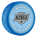 NHL Los Angeles Kings New Fan Is Born blue souvenir hockey puck with silver and black Kings shield logo on baby-themed background