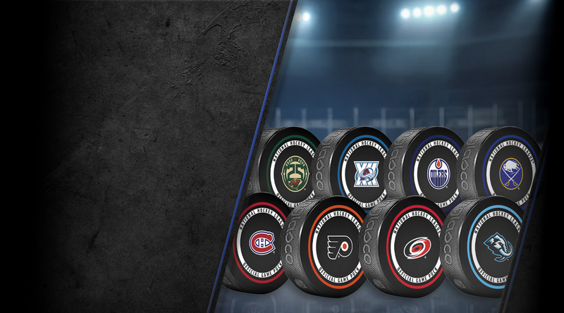 NHL team souvenir pucks collection desktop banner showing eight assorted club logos on dark arena backdrop